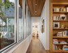 Hallway to Master bedroom suite with views to rear yard and adjacent pocket office. Photo 13 of Vance Lane Residence modern home