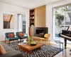The Living room gets plenty of natural light and views to the pool. Cabinet and fireplace composition of vertical grain white oak, walnut and blackened steel. Photo 12 of Vance Lane Residence modern home