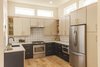 Modern home with Kitchen, Microwave, Undermount Sink, Colorful Cabinet, Open Cabinet, Refrigerator, Stone Tile Backsplashe, Wood Cabinet, Engineered Quartz Counter, Recessed Lighting, and Light Hardwood Floor. Unit B - Kitchen - We played with a lot of colors here and a small space that ends up feeling rather large. Photo 6 of The Reyes Duplex
