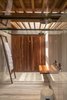 One of the luxurious bathrooms in Casa Santísimo by JJRR Arquitectura. It maintains a sense of natural intimacy despite its open plan and skylight ceiling. Photo 12 of Santísimo House modern home