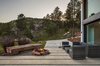 Modern home with Outdoor, Front Yard, Shrubs, Grass, Hardscapes, Trees, Boulders, Large Patio, Porch, Deck, and Concrete Patio, Porch, Deck. Main House Fire Pit Photo 3 of The Tesla of Boulder Homes Offered at $3,950,000