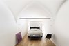 Modern home with Bedroom, Bed, Wardrobe, Accent Lighting, Ceiling Lighting, and Medium Hardwood Floor. In contrast to the resin flooring of the first level the night zone features an oak wooden parquet flooring except for the bathroom. Photo 8 of EXISTENZ MINIMUM- Palermo House A223