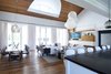 Modern home with Living Room, Chair, Sofa, Coffee Tables, End Tables, Console Tables, Ceiling Lighting, Table Lighting, Accent Lighting, Pendant Lighting, Bookcase, and Medium Hardwood Floor. Great Room Photo 5 of Bahamian Retreat