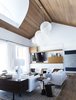 Modern home with Living Room, Sofa, Bookcase, Coffee Tables, Chair, Console Tables, End Tables, Ceiling Lighting, Floor Lighting, Pendant Lighting, Medium Hardwood Floor, and Table Lighting. Great Room Photo 4 of Bahamian Retreat