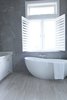 Modern home with Bath Room, Marble Counter, Travertine Floor, Drop In Sink, Freestanding Tub, Enclosed Shower, Ceiling Lighting, Ceramic Tile Wall, and One Piece Toilet. Master Bathroom Photo of Bahamas Style