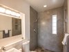 Modern home with Bath Room, Concrete Wall, Tile Counter, Ceiling Lighting, Full Shower, Open Shower, Wall Lighting, Wall Mount Sink, and Ceramic Tile Floor. Renovated bathroom with custom cabinetry and hand poured concrete tiles. Photo 9 of One Of A Kind Santa Fe Modern Home