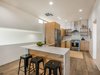 Modern home with Kitchen, Medium Hardwood Floor, Undermount Sink, Quartzite Counter, Refrigerator, Dishwasher, Ceramic Tile Backsplashe, Range, Subway Tile Backsplashe, Wood Cabinet, Dark Hardwood Floor, Range Hood, and Ceiling Lighting. Waterfall counter tops Photo 17 of One Of A Kind Santa Fe Modern Home