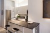 Modern home with Kitchen, Stone Counter, White Cabinet, Track Lighting, Stone Tile Backsplashe, Recessed Lighting, Refrigerator, Undermount Sink, Wine Cooler, and Ceramic Tile Floor. Kitchen Photo 7 of Robert and Hélène's loft