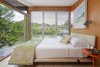 Modern home with Bedroom, Bed, Night Stands, Ceramic Tile Floor, and Wall Lighting. The bright, earth-toned textiles celebrate the intent of creating a home where one can be indoors and fully indulge in the natural beauty outside. Photo 8 of The Cocoon House