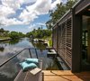 Modern home with Outdoor, Decking Patio, Porch, Deck, Small Patio, Porch, Deck, Wood Patio, Porch, Deck, and Back Yard. The balcony reaches past the structure and is complete with integrated seating creating the perfect spot to enjoy Gulf Coast sunsets over the tranquil bayou beyond. Photo 4 of The Cocoon House