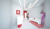 The interior is dominated by white color, as a representation of cleanness. The smooth, curvy entrance hall expands into the waiting room. The red design elements are derived from the two-colored logo of the clinic.
Despite the limitations presented by formerly existed layout, to which the new aesthetics had to be applied, current design came to life as a harmonious piece of its own.
Photo 6 of Kuzanov Clinic modern home
