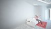 The interior is dominated by white color, as a representation of cleanness. The smooth, curvy entrance hall expands into the waiting room. The red design elements are derived from the two-colored logo of the clinic.
Despite the limitations presented by formerly existed layout, to which the new aesthetics had to be applied, current design came to life as a harmonious piece of its own.
Photo 5 of Kuzanov Clinic modern home