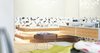Previously existing walls were brought down, in order to create an open space, unifying a kitchen, a dining room and a living room. Merging aesthetic continues on to the bedroom, where two sinks and the wardrobe become the part of the room, as opposed to traditional approach of keeping them locked away from eye.
The apartment overlooks the city and the mountains, and for the outer visual richness to be fully embraced, the windows were enlarged to the wall scale.
Photo 17 of Double N Residence modern home
