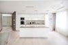 The house is spacious and the interior was designed in a manner, which kept this aspect highlighted: the entrance corridor leads to the large open area, uniting the kitchen, the living room and the dining room; The guest room wall, concealing the wardrobe, has two large incisions, making the wardrobe still part of the bedroom. Compelling design choice was also made for the master bedroom, where two sinks are not shying away from eye, but are rather put on display, as integral element of the bedroom.
Photo 2 of InnerEdges modern home