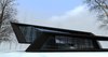 The structure emerged after 6 hour sketching as a parallel experience to the ongoing construction processes of Mestia airport and Sarpi border checkpoint. The forms are radically opposed to the rounder shapes of above-mentioned buildings. The exterior has a sense of unity, as if a black matter was folded up into harmonious angular shapes.
The purpose of the space was to create a personal getaway into nature, providing a resident with peaceful environment for work and relaxation. The glass walls assure an insider to have a nature on display at all times. The inner space is divided into 2 parts: the lower one is the main area combining the kitchen and the bathroom and the upper territory is occupied by the bedroom and the workstation. The latest is extended out, creating the parking spot beneath it. The angular plane on the opposite end is the terrace, securing the idea of having a personal space outdoors, while being a visitor to a nature.
The loft is the only architectural work in large area and it was intentionally designed as a sculptural piece.
Photo 2 of Blackbird modern home