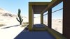 The desert loft resident is involved in off-road activities and required a place, which would sustain its appearance through sandstorms and extensive heat. The massive metal structure elegantly sits in the harsh environment.
The entrance door, secluded behind the thick metal screen, leads to the largest area of the house, unifying the kitchen, the dining room and the living room. The hall connects to three bedrooms and the bathroom.
The dining room exits to the terrace with the fireplace, carved in the floor. the ceiling is hollowed out right above it, following the lines of the round cut out in the floor. The gap's presence is almost poetic, as if it's the only passage transferring the smoke to the sky.
Photo 3 of Warmhole modern home