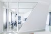 As soon as you enter the space, the core aesthetic of the design unfolds and it is only possible to see the main room through the tilted hallway. It meant to take your time for the idea of an actual comfort, smartness and practicality of the design to sink in. When navigating further into the room, one realizes, that the slopes direct the visitor from the narrow spaces toward the wider ones and vice versa. Leaning walls bend the space, making it simultaneously modest and sharp.
The intention of diagonal walls being directional carries through the bedroom as well, but here, the steepness accentuates the workstation. In the case of the bathroom, the slope serves as a surface to lean on and relax. Photo 12 of Cave modern home