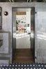 Modern home with Doors and Interior. Looking from the bathroom to the living space through the portal, which houses a small closet, and also provides a spatial and material transition from private to public space . Photo 11 of Garner Pool & Casita