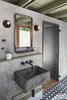 Modern home with Bath Room, Wall Mount Sink, Wall Lighting, and Cement Tile Floor. The new casita bathroom features a custom concrete sink, plaster walls, and custom concrete tile. Photo 8 of Garner Pool & Casita