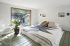 Modern home with Bedroom, Wall Lighting, Bed, Chair, Painted Wood Floor, and Storage. The small sleeping loft integrates plaster niches for storage. Photo 7 of Garner Pool & Casita