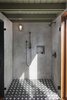 Modern home with Bath Room, Cement Tile Floor, Wall Lighting, Full Shower, and Enclosed Shower. The concrete tile transitions into the plaster shower for a seamless look. Photo 9 of Garner Pool & Casita