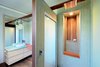 Ensuite... glass tiles, wall panels and benchtops. Creating beautiful spaces in every room Photo 8 of South Coast Serendipity modern home