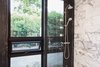 Modern home with Bath Room, Engineered Quartz Counter, Undermount Sink, Open Shower, Wall Lighting, Marble Wall, and One Piece Toilet. guest bathroom detail Photo 4 of Glendessary Lane