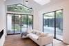 Modern home with Living Room, Sofa, Ceiling Lighting, Pendant Lighting, Medium Hardwood Floor, Ribbon Fireplace, and Gas Burning Fireplace. living room Photo 6 of Glendessary Lane