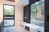 Modern home with Bath Room, Engineered Quartz Counter, Undermount Sink, Porcelain Tile Floor, Freestanding Tub, Open Shower, Ceiling Lighting, Wall Lighting, Pendant Lighting, Accent Lighting, Glass Tile Wall, and One Piece Toilet. master bathroom Photo 8 of Glendessary Lane