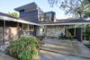 Modern home with Horizontal Fences, Wall, Wood Fences, Wall, Garden, Front Yard, Rooftop, Woodland, Slope, Trees, Hardscapes, Shrubs, Boulders, Walkways, Outdoor, and Vertical Fences, Wall. Front entry Photo 3 of Alpine Street