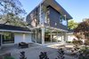 Modern home with Wood Fences, Wall, Horizontal Fences, Wall, Front Yard, Trees, Rooftop, Garden, Woodland, Shrubs, Hardscapes, Boulders, Walkways, Concrete Patio, Porch, Deck, Gardens, and Outdoor. Living room garden looking north east Photo 4 of Alpine Street