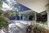 Modern home with Wood Fences, Wall, Garden, Shrubs, Boulders, Trees, Woodland, Hardscapes, Rooftop, Walkways, Side Yard, Gardens, Small Patio, Porch, Deck, Concrete Patio, Porch, Deck, Hanging Lighting, and Outdoor. Living room garden looking west Photo 5 of Alpine Street