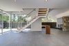 Modern home with Wood Fences, Wall, Horizontal Fences, Wall, Sliding Window Type, Metal, Porcelain Tile Floor, Console Tables, Corner Fireplace, Gas Burning Fireplace, Recessed Lighting, Outdoor, and Vertical Fences, Wall. Living room- Entry & Den Photo 6 of Alpine Street