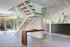 Modern home with Wood Fences, Wall, Shrubs, Garden, Trees, Woodland, Hardscapes, Boulders, Walkways, Small Patio, Porch, Deck, Hanging Lighting, Concrete Patio, Porch, Deck, Gardens, Side Yard, Horizontal Fences, Wall, Metal, Porcelain Tile Floor, Sliding Window Type, Console Tables, Cable Railing, and Wood Railing. Stairway @ front entrance & Den Photo 7 of Alpine Street