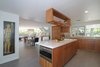 Modern home with Kitchen, Glass Tile Backsplashe, Wood Cabinet, Porcelain Tile Floor, Ceiling Lighting, Engineered Quartz Counter, Recessed Lighting, Refrigerator, Microwave, and Undermount Sink. Kitchen Dining and Living areas Photo 11 of Alpine Street
