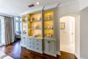 Master bedroom display cabinet for the client’s antiquities. Photo of Modernized English Style modern home