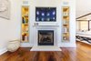 Custom cabinetry around custom limestone fireplace in sitting room off master bedroom where TV is viewed. Photo 3 of Modernized English Style modern home