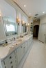 Master bath his and her sinks with tub chandelier reflecting in the mirror. Photo 6 of Modernized English Style modern home