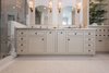 Master bath cabinetry makes a statement with the symmetry and custom hand-beaded inset doors. Photo 9 of Modernized English Style modern home