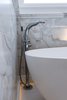 Polished chrome tub filler with wand and recessed baseboard lighting to give a romantic glow in the bathroom when the overhead lights are dimmed or off. Photo 10 of Modernized English Style modern home