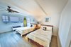 Bright and sunny guest room with casual furnishings and a surfer theme. Photo 2 of Streamlined Cape Cod at The Wedge modern home