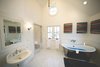 Master bathroom with vaulted ceiling and imported stainless tub create the ultimate bathing experience. Photo 4 of Streamlined Cape Cod at The Wedge modern home