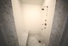 1920s inspired walk in shower with marble trim and seats. Photo 5 of Streamlined Cape Cod at The Wedge modern home