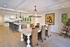 Magnificent open plan kitchen and dining room with extra large Island. Photo 8 of Streamlined Cape Cod at The Wedge modern home