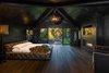 Master bedroom with views of the backyard. Photo 2 of Malibu Lake House modern home