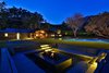 Backyard with infinity pool, seating and fire pit. Photo 9 of Malibu Lake House modern home