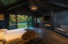 Master bedroom with fireplace. Photo 10 of Malibu Lake House modern home