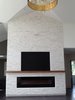 Quartz stacked white stone fireplace which stands 22 ft high with an exotic zebra wood mantel. 96" built in fireplace. 24" wide black and gold pendant, glimmering rings to the round gold finish canopy. Photo 3 of The Swanson/Marconi House modern home
