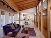Modern home with Bench, Sofa, Chair, Bookcase, Media Cabinet, Pendant Lighting, Light Hardwood Floor, Wall Lighting, and Living Room. A family room addition connects the existing historic townhouse to an adjacent walled garden. Photo 3 of Urban Garden House
