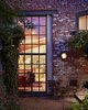 Modern home with Trees, Back Yard, Flowers, Shrubs, Large Patio, Porch, Deck, Hardscapes, Gardens, Walkways, Exterior, Metal, Swing Door Type, Windows, and Picture Window Type. A steel window system infills the garden wall's existing masonry opening. Photo 9 of Urban Garden House